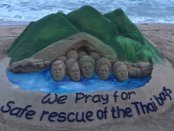 As rescue operation at the cave site in northern Thailand is underway, International sand artist Sudarshan Pattnaik created a sand sculpture on the same theme at Puri Beach in Odisha. Depicting boys stuck inside the cave, the message on the sculpture read, "We pray for the safe rescue of the Thai boys." Pattnaik used five tons of sand for his 'Thai Cave Rescue' creation and it took him three hours to complete the 4 ft high piece of art. Sand artist Sudarshan Pattnaik,Sudarshan Pattnaik,Sudarshan Pattnaik sand art,Sudarshan Pattnaik sand art pics,Sudarshan Pattnaik sand art images,Thai Cave Rescue,Thai Cave Rescue sand art