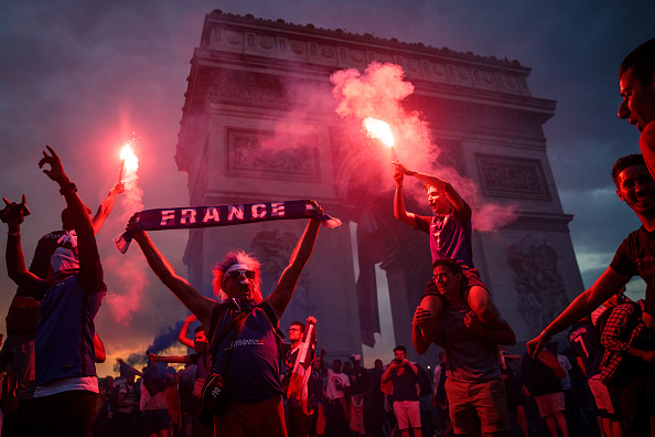 French football fans celebrate with smoke grenades in front of the Arc de Triomph after France's victory against Croatia in the World Cup Final on July 15, 2018. Fifa World Cup 2018,Fifa World Cup,Fifa World Cup winner,France,Frace beats Croatia,Croatia,France fans celebrate in Paris