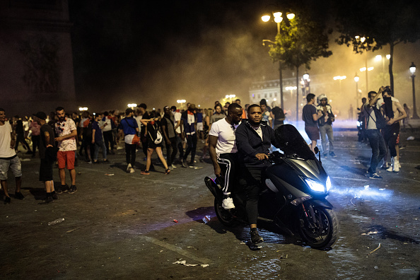 French football fans celebrate with smoke grenades in front of the Arc de Triomph after France's victory against Croatia in the World Cup Final on July 15, 2018 in Paris, France. France beat Croatia 4-2 in the World Cup Final. Fifa World Cup 2018,Fifa World Cup,Fifa World Cup winner,France,Frace beats Croatia,Croatia,France fans celebrate in Paris