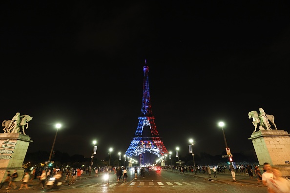 The Eiffel Tower is illuminated Blue, White and Red, colors of the french flag, as a tribute to the french football team who won the world cup for the second time in history on July 15, 2018, in Paris. Fifa World Cup 2018,Fifa World Cup,Fifa World Cup winner,France,Frace beats Croatia,Croatia,France fans celebrate in Paris