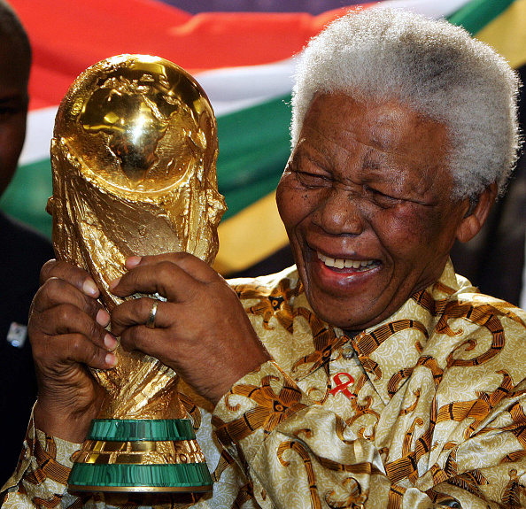 South African former President Nelson Mandela holds the Jules Rimet World cup, 15 May 2004 at the FIFA headquarters in Zurich. South Africa won the right to host the 2010 World Cup finals, the first to be played in Africa, football's world governing body FIFA announced here 14 May, 'The 2010 World Cup will be organised by South Africa,' said FIFA President Sepp Blatter. Nelson Mandela 100th birthday,Nelson Mandela birthday,Nelson Mandela rare pics,Nelson Mandela rare images,Nelson Mandela rare stills,Nelson Mandela rare pictures,Nelson Mandela rare photos,Nelson Mandela unseen pics,Nelson Mandela unseen images,Nelson Man