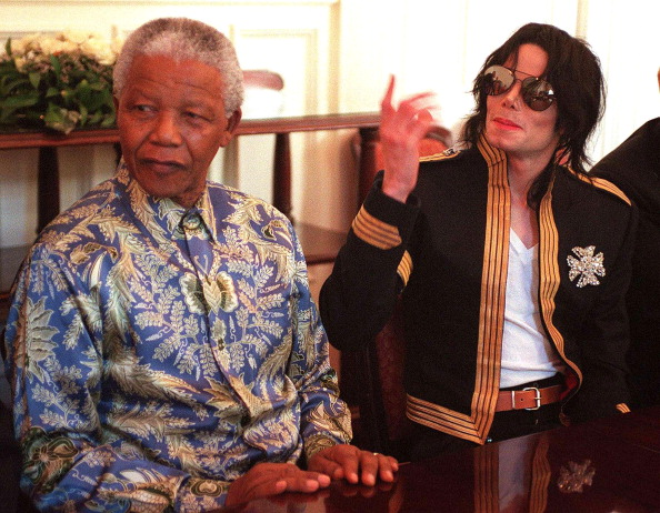 US singer Michael Jackson (R) gestures during a press conference with President Nelson Mandela at the President's home Genadendal in Cape Town 23 March 1999. Michael Jackson announced his latest project, 'Michael Jackson and Friends - The Adventure of Humanity' which will raise money to aid needy people around the world. The Nelson Mandela Children's Fund, UNESCO and the Red Cross are amongst the organisations which will benefit from the project which will include two concerts. Nelson Mandela 100th birthday,Nelson Mandela birthday,Nelson Mandela rare pics,Nelson Mandela rare images,Nelson Mandela rare stills,Nelson Mandela rare pictures,Nelson Mandela rare photos,Nelson Mandela unseen pics,Nelson Mandela unseen images,Nelson Man