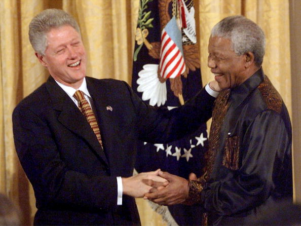 US President Bill Clinton (L) shakes hands with South African President Nelson Mandela (R) at a reception for African American religious leaders, black college presidents and members of the Congressional Black Caucus in the East Room of the White House 22 September. President Mandela is in Washington, DC to receive the Congressional Medal of Honor 23 September. Nelson Mandela 100th birthday,Nelson Mandela birthday,Nelson Mandela rare pics,Nelson Mandela rare images,Nelson Mandela rare stills,Nelson Mandela rare pictures,Nelson Mandela rare photos,Nelson Mandela unseen pics,Nelson Mandela unseen images,Nelson Man