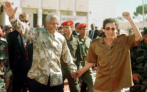 South African President Nelson Mandela (L) and Libyan leader Moamer Kadhafi join hands in a victory gesture 22 October 1997 in front of Kadhafi's home which was destroyed by a US fighter raid in 15 April 1986. Mandela arrived here for talks with Kadhafi in defiance of US criticism over the visit. Nelson Mandela 100th birthday,Nelson Mandela birthday,Nelson Mandela rare pics,Nelson Mandela rare images,Nelson Mandela rare stills,Nelson Mandela rare pictures,Nelson Mandela rare photos,Nelson Mandela unseen pics,Nelson Mandela unseen images,Nelson Man