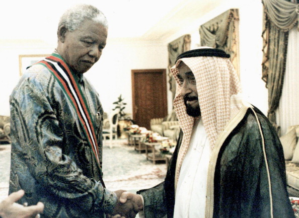 UAE President Zayed ibn Sultan al-Nahayan shakes hands with his South African counterpart Nelson Mandela (L), 07 December in Abu Dhabi. Mandela is in the United Arab Emirates to take part in a summit of Gulf States which will urge Iraq to bow to UN demands and Iran to seek a peaceful end to a dispute over three Gulf islands. UN chief Kofi Annan, Arab League Secretary General Esmat Abdel Meguid and Ezzedin Laraki, head of the Organisation of Islamic Conference (OIC) will also attend the summit. Nelson Mandela 100th birthday,Nelson Mandela birthday,Nelson Mandela rare pics,Nelson Mandela rare images,Nelson Mandela rare stills,Nelson Mandela rare pictures,Nelson Mandela rare photos,Nelson Mandela unseen pics,Nelson Mandela unseen images,Nelson Man
