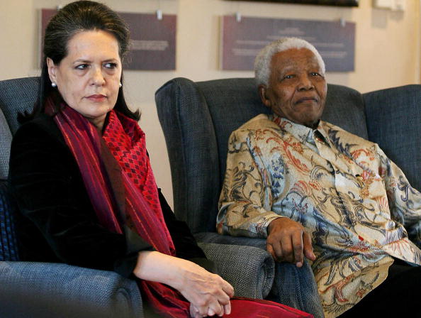 Former South African president and Nobel peace prize laureate Nelson Mandela (R) receives, 22 August 2007 Sonia Gandhi (L), the President of the Indian National Congress and the leader of the ruling Indian Congress Alliance at the Mandela Foundation in Johannesburg during her four day working visit to South Africa. Gandhi presented a smiling Mandela with a book entitled 'Gandhi's Way' which celebrated a centenary of Mahatma Gandhi's philosophy of peace and humanity. Nelson Mandela 100th birthday,Nelson Mandela birthday,Nelson Mandela rare pics,Nelson Mandela rare images,Nelson Mandela rare stills,Nelson Mandela rare pictures,Nelson Mandela rare photos,Nelson Mandela unseen pics,Nelson Mandela unseen images,Nelson Man