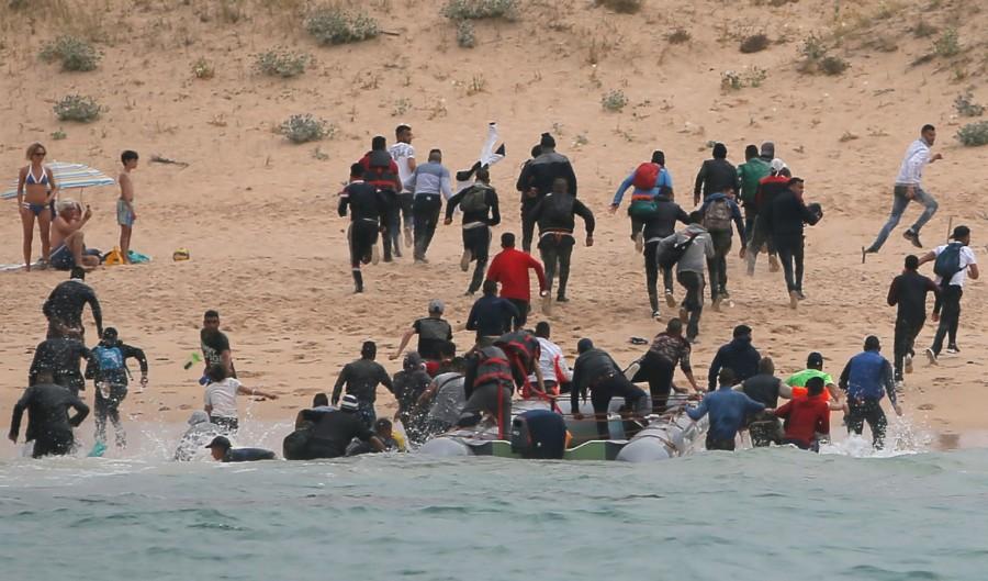 The moment migrants land on a packed beach in Spain Boat full of migrants,Spanish beach,migrants on Spanish beach,30 illegal migrants