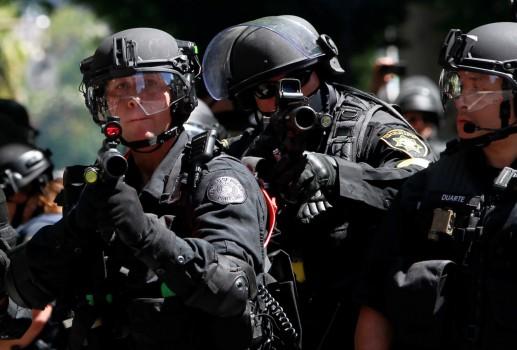 Police fire projectiles at counter-protesters during a rally