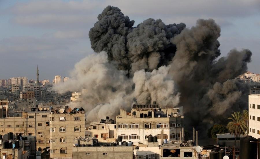 Smoke rises after an Israeli aircraft bombed a multi-storey building Israeli aircraft struck,Israeli aircraft,Israeli airstrikes Gaza,Gaza,Palestinian militants,Israel attacks Gaza