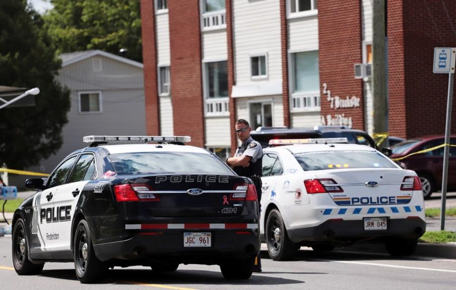 Fredericton Police and Royal Canadian Mounted Police (RCMP) patrol in front of the apartment New Brunswick shooting,Brunswick shooting,eastern Canada