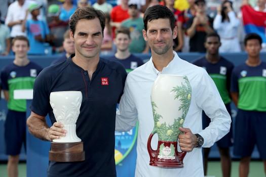 Roger Federer of Switzerland and Novak Djokovic of Serbia pose for photographers after their match