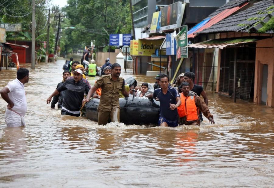 Rescuers evacuate people from a flooded area Kerala floods,Kerala floods pics,Kerala floods images,Kerala floods stills,Kerala floods pictures,Kerala floods photos,Kerala worst flood