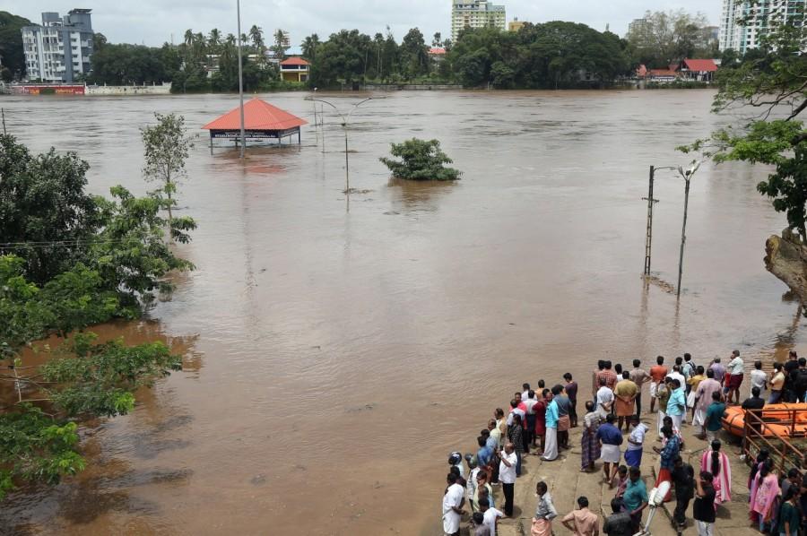 People stand on the steps of Aluva Shiva Temple complex Kerala floods,Kerala floods pics,Kerala floods images,Kerala floods stills,Kerala floods pictures,Kerala floods photos,Kerala worst flood
