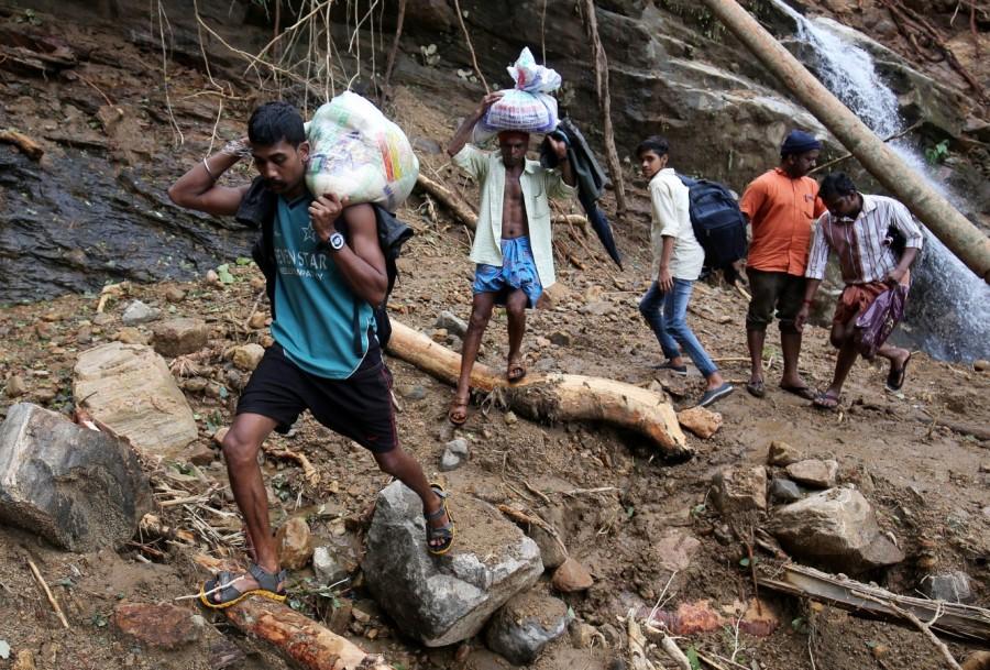 Flood victims carry relief material Kerala floods,Kerala floods pics,Kerala floods images,Kerala floods stills,Kerala floods pictures,Kerala floods photos,Kerala worst flood