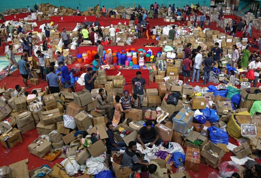 Volunteers work at an aid distribution centre Kerala floods,Kerala floods pics,Kerala floods images,Kerala floods stills,Kerala floods pictures,Kerala floods photos,Kerala worst flood