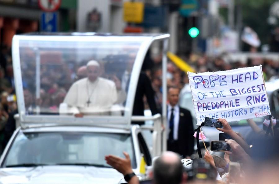 A protestor holds a banner as Pope Francis visit Dublin Pope Francis,Pope Francis visits Ireland,Pope Francis in Ireland,papal visit