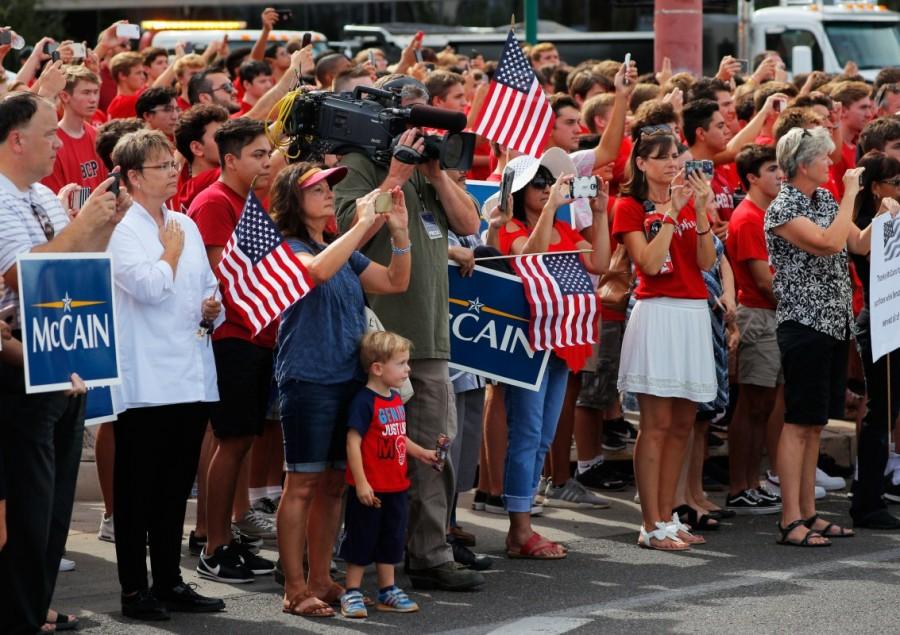 Bystanders look on as a motorcade carrying the casket of Senator John McCain Honoring John McCain,Honoring for John McCain,John McCain,US senator John McCain,John McCain dead,John McCain memorial,John McCain memorial pics,John McCain memorial images,John McCain memorial stills,John McCain memorial pictures,John McCain memorial pho