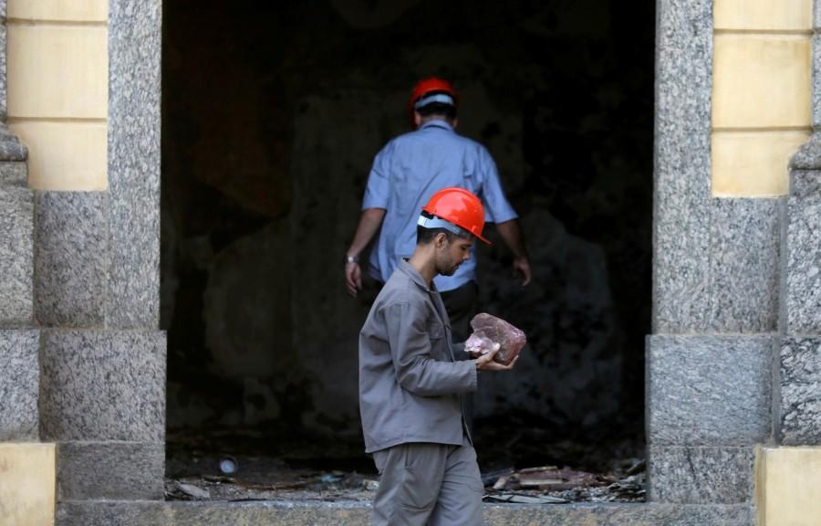 Worker carries a piece of a rock National Museum,Brazil National Museum,fire destroys national museum,200-year-old National Museum,Rio de Janeiro