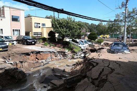 A car is stuck on a road damaged by an earthquake in Sapporo
