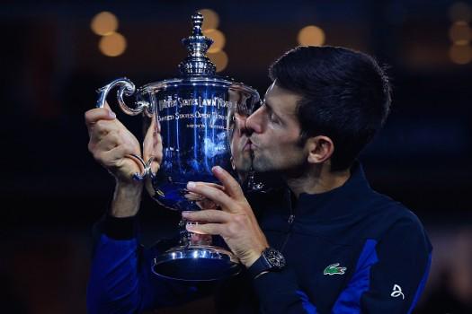 Novak Djokovic of Serbia poses with championship trophy after winning