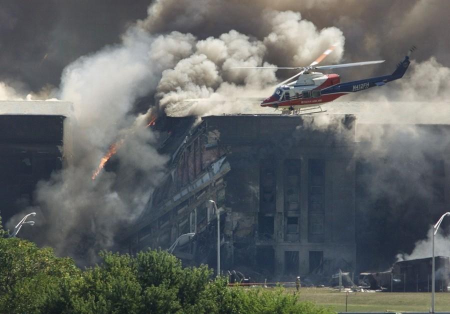 A rescue helicopter surveys damage to the Pentagon as firefighters battle flames World Trade Center,World Trade Center attack,September 11 attack,Twin Towers attack,pentagon attack,9/11,9/11 pictures,World Trade Center attack pictures,powerful post attack pictures,United States,hijacked airplane,New York City,Pentagon building,north t