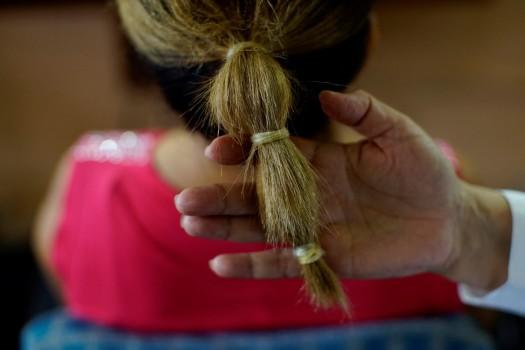 Stylist Sandra Hernandez shows condoms used as as hairbands