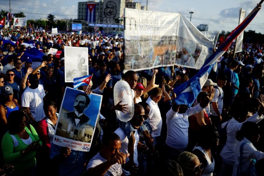 A child carries an inflated condom during the May Day rally From fishing to tying hair,Condom Uses,Condom Use,Condom Use Goes Far Beyond Sex,condom usage,Cuba goes far beyond sex